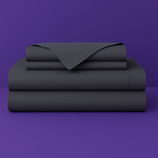 This image shows a neatly folded stack of dark grey bed sheets on a vibrant purple background. The stack includes what appears to be a fitted sheet, flat sheet, and pillowcases. The sheets have a smooth, crisp appearance suggesting high-quality bedding. The top sheet has a folded corner revealing the edge detail.