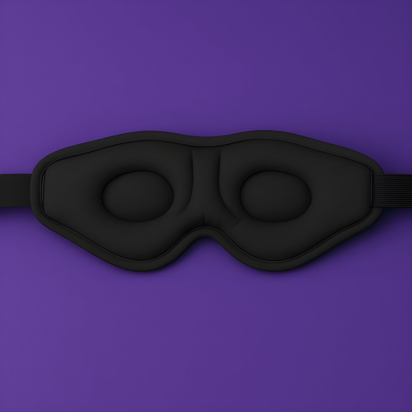 3D contoured sleep mask with padded eye cups on purple background, featuring elastic headband and premium memory foam for pressure-free comfort and total blackout for better sleep.