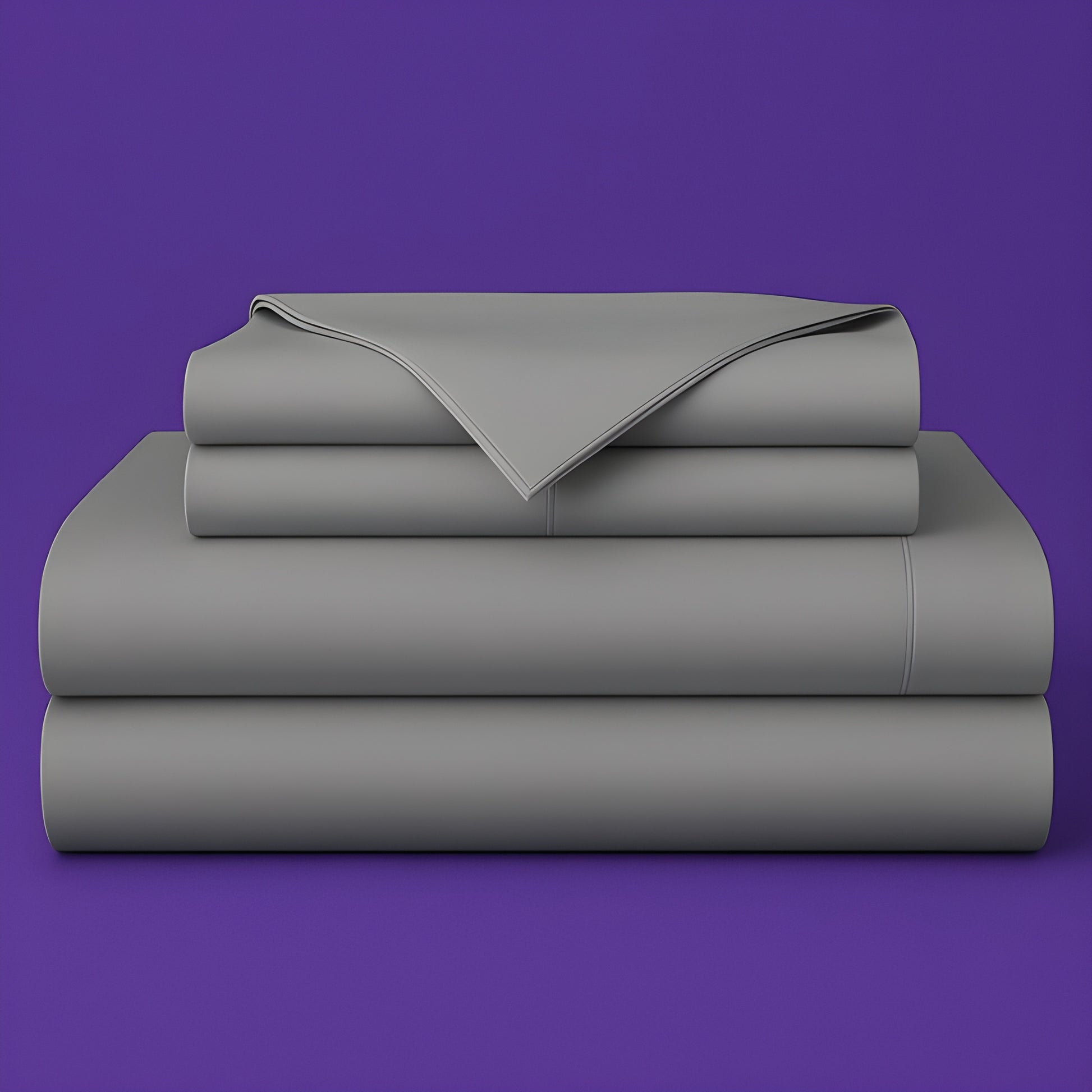 This image shows a neatly folded stack of gray bed sheets on a vibrant purple background. The stack includes what appears to be a fitted sheet, flat sheet, and pillowcases. The sheets have a smooth, crisp appearance suggesting high-quality bedding. The top sheet has a folded corner revealing the edge detail.