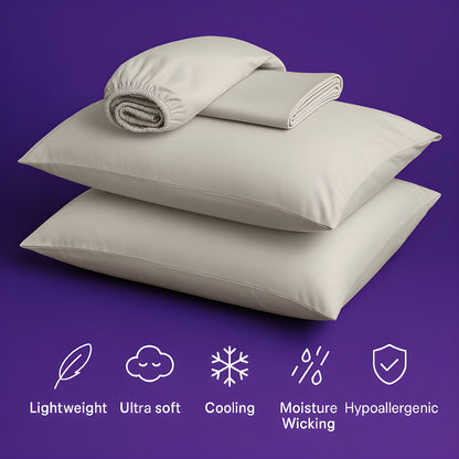A luxurious set of premium cream-colored bedding displayed on a rich purple background. The image features two plush pillows stacked together with a fitted sheet and flat sheet arranged on top. Below the bedding are five white icons highlighting key product features: "Lightweight" (feather icon), "Ultra soft" (cloud icon), "Cooling" (snowflake icon), "Moisture Wicking" (water droplets icon), and "Hypoallergenic" (shield icon).