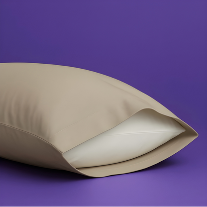Elegant cream-colored pillowcase with a white pillow partially visible inside, set against a rich purple background. The premium pillowcase features a clean envelope closure design that securely holds the pillow while maintaining a sleek appearance.