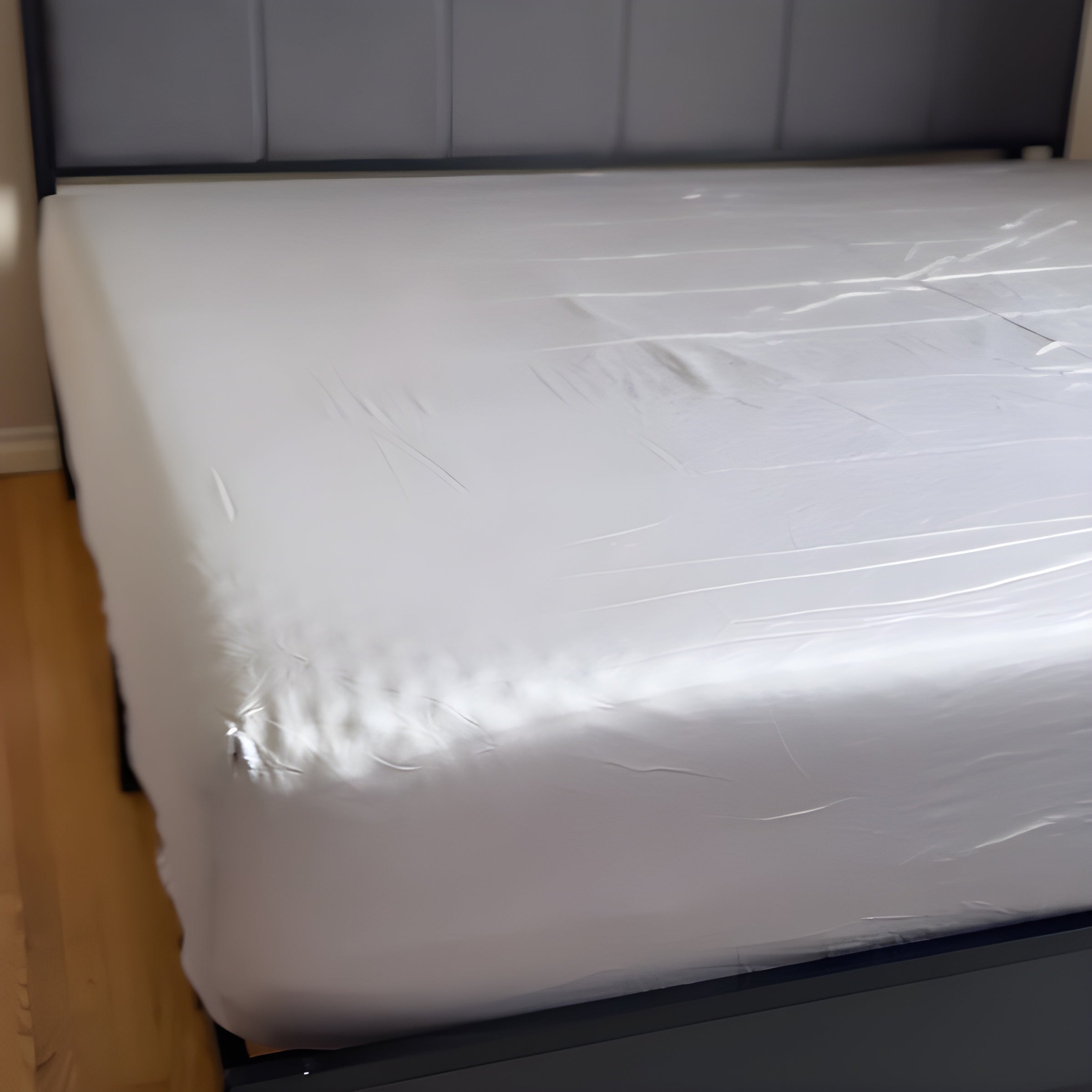 A neatly made bed with grey-colored sheets