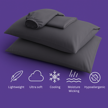 A luxurious set of premium dark gray bedding displayed on a rich purple background. The image features two plush pillows stacked together with a fitted sheet and flat sheet arranged on top. Below the bedding are five white icons highlighting key product features: "Lightweight" (feather icon), "Ultra soft" (cloud icon), "Cooling" (snowflake icon), "Moisture Wicking" (water droplets icon), and "Hypoallergenic" (shield icon).