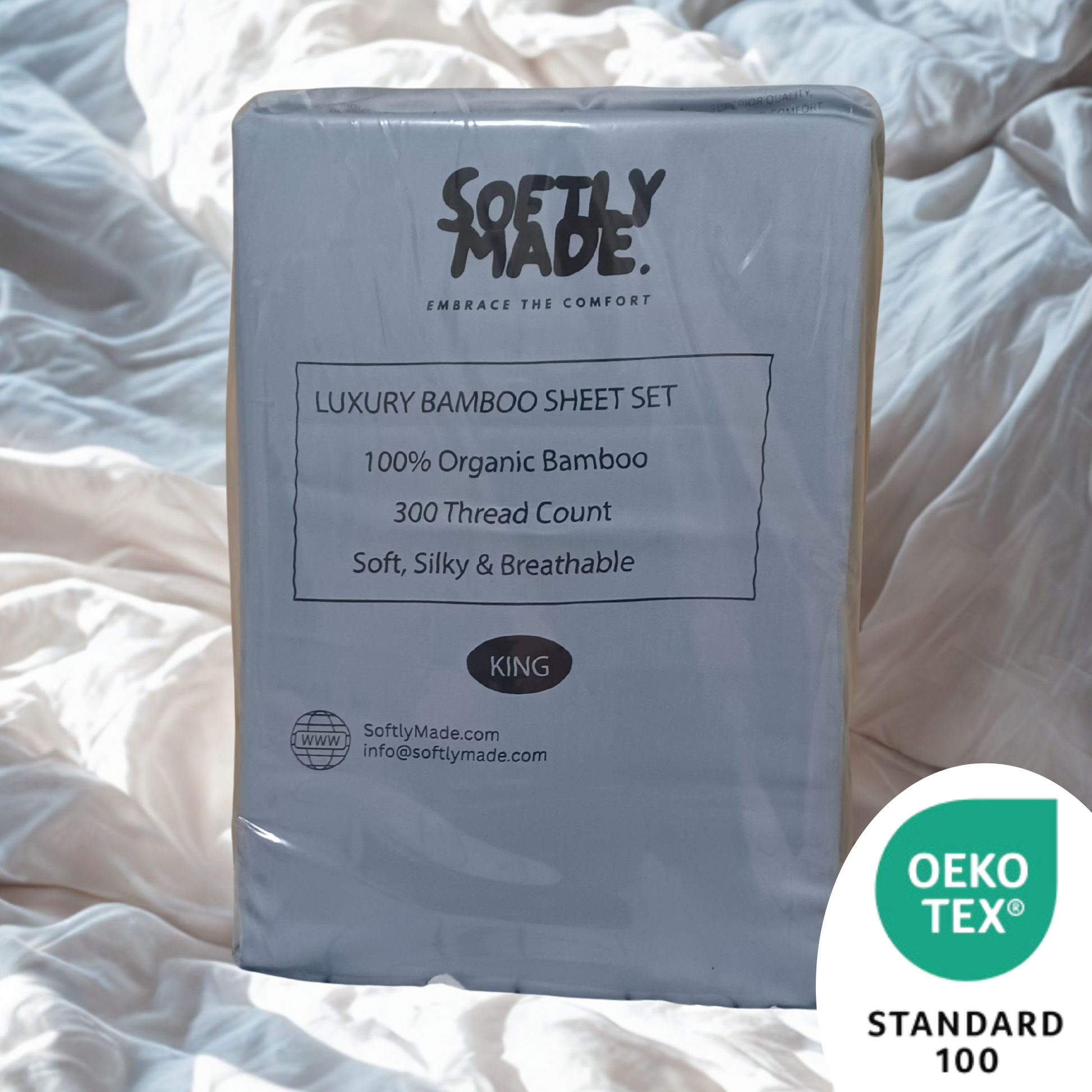 Packaged SOFTLY MADE luxury bamboo sheet set on a bed with OEKO-TEX Standard 100 logo.
