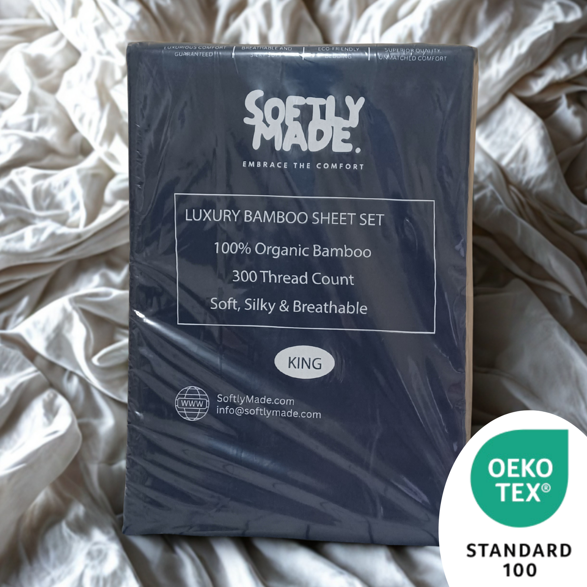 Packaged Softly Made luxury bamboo sheet set on a bed with OEKO-TEX Standard 100 logo.