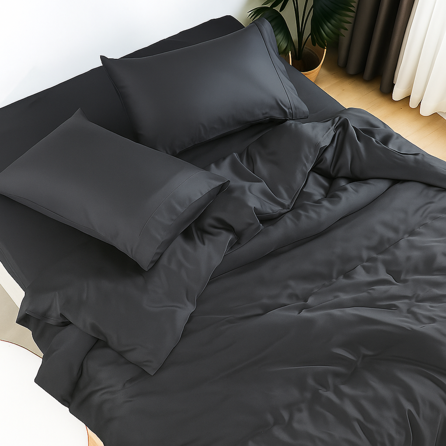 Dark gray bedding set on a bed with pillows and comforter.