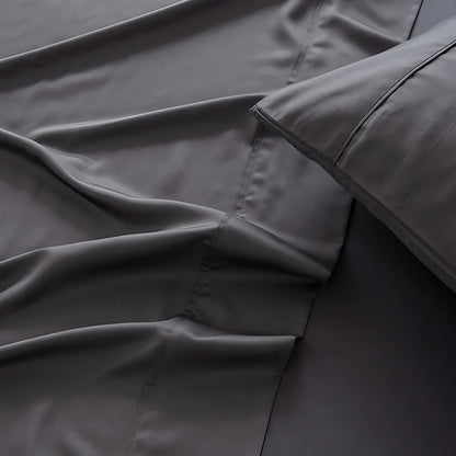 Close-up of dark gray bedding with a focus on texture and folds.