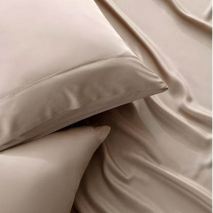 Close-up of beige pillows and bed sheets with a soft texture.