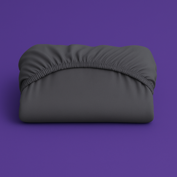 Premium dark gray fitted sheet with elastic edge displayed on a vibrant purple background. The sheet features a smooth, wrinkle-resistant fabric with deep pockets and secure elastic banding that ensures a perfect fit on mattresses.