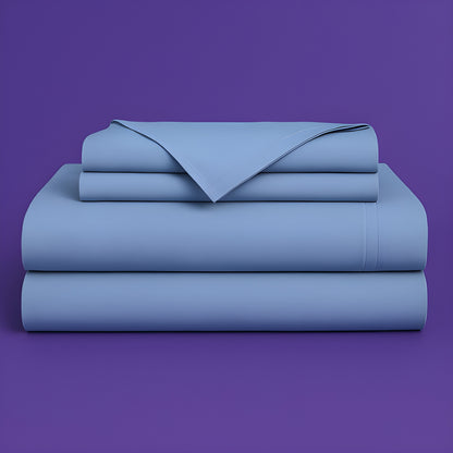This image shows a neatly folded stack of light blue bed sheets on a vibrant purple background. The stack includes what appears to be a fitted sheet, flat sheet, and pillowcases. The sheets have a smooth, crisp appearance suggesting high-quality bedding. The top sheet has a folded corner revealing the edge detail.