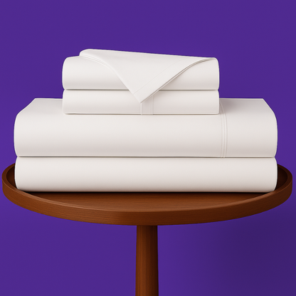 SoftlyMade premium white bamboo bed sheets neatly folded on wooden round table against purple background. Luxury bedding set with flat sheet, fitted sheet and pillowcases for comfortable sleep.
